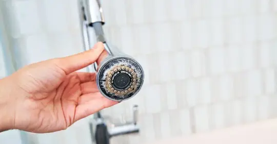 faucet covered in limescale buildup